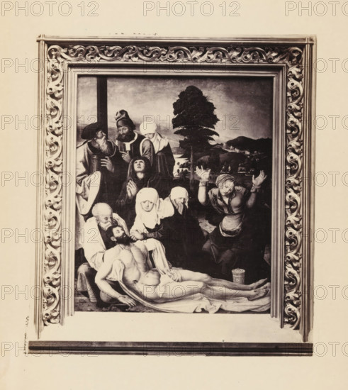Photographic reproduction of a painting of the Descent from the Cross of Christ, possibly by Matthias Grünewald, photograph, reproduction, page, photographer: Gysi, after painting by Matthias Grünewald (possibly), c. 1856 - in or before 1866, paper, albumen print, height 132 mm x width 119 mm, picture, painting, Christ is laid down, descent from the cross, A framed rectangular painting with an ornate carved frame surrounding a scene of multiple figures clustered around a lifeless male figure lying on a draped surface, the central figure nude from the waist up with arms and legs extended, nearby figures wearing head coverings and robes with varied expressions and gestures, one woman raising her hands, another supporting the head of the fallen man, a bearded man and other attendants grouped at the upper left, a tree and distant landscape visible in the background, and a patterned cylindrical container near the feet of the central figure.