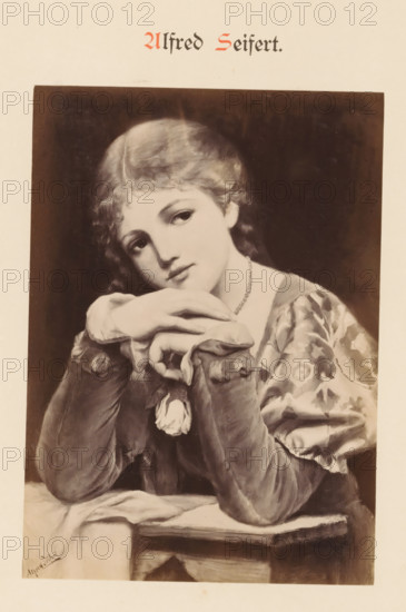 Photo reproduction of a painting by Alfred Seifert, depicting a portrait of a woman with a rose in her hand, Alfred Seifert, photograph, reproduction, page, photographer: Franz Hanfstaengl (possibly), Munich, c. 1875 - c. 1885, Bavaria, paper, albumen print, height 135 mm x width 96 mm, Photo on page 24., picture, painting, adult woman, flowers: rose, A monochrome portrait of a young woman leaning on folded hands with her chin resting on them, wearing a patterned dress with puffed sleeves and a beaded necklace, her hair short and wavy, eyes gazing slightly to the side and a small flower pinned near her wrist, set against a dark rectangular background on a lighter page.