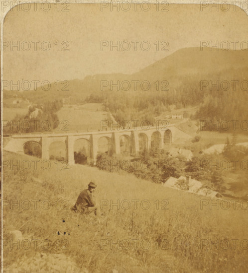 The Semmering. Viaduct Adlitzgrapen. Austria, View of an alpine landscape with the Fleischmann viaduct in Semmering, Austria, Views and landscapes in Europe, Africa and Asia, Geographical Sculpture Gallery, collected by MJ Broekhuijsen, Head of a school in Amsterdam, stereograph, Bottom left of photo numbered: 75., annotation: 'Alps. Austria', annotation: 'The Semmering railway is part of the railway from Vienna to Trieste, on the border between Styria and Austria. The construction of this section of the line required an enormous amount of effort., Over a length of ten hours' walk one finds fifteen tunnels, some of which are more than 1000 m long, as well as eighteen viaducts, some more than 100 m long. The viaduct in the image is 151 m long and 24 m high. Due to the many curves, the line is almost three times as long as the distance between the two endpoints. The construction costs of the Semmeringbaan amounted to six rows of rijksdaalders, as long as the entire railway line.', Semmer...