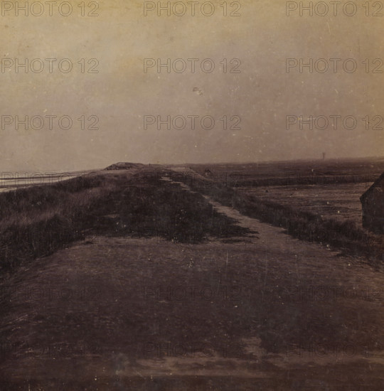 Just wide enough, View of the dune strip near Ter Heijde, Views and landscapes in Europe, Africa and Asia, Geographical Sculpture Gallery, collected by MJ Broekhuijsen, Headmaster of a school in Amsterdam, stereograph, Numbered A.4. at the bottom left of the photo, annotation: 'is near Ter Heijde the dune strip, continually excavated further by humans, to enlarge the area of the geestgronden on the right. Compare the height of the sea level and of the geestgrond., Rectangular on the dune strip in the sea are the piers.', Ter Heijde, publisher: Merkelbach & Co., Amsterdam, compiler (person in literature): Martien Johan Broekhuijsen, c. 1905, photographer, compiler (person in literature), pasteboard, paper, albumen print, height 87 mm x width 177 mm, Part of a group of 52 stereophotos used in primary education as a supplement to school charts. The entire series consisted of 274 items in 10 categories (A to K)., Dune Coast, A muted landscape with a wide expanse of sky above a low, rolling...