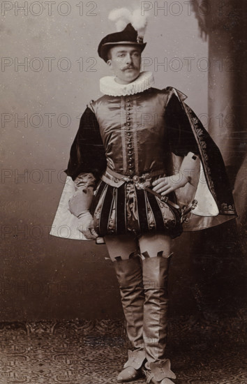 Portrait of Cornelis Hoogendijk in costume, album page, photograph, carte-de-visite, This photo is part of an album., inscription: 'J. Goedeljee, Photographer, HRH PRINCE ALEXANDER of the Netherlands, PRINCE of ORANGE, and HRH PRINCESS HENDRIK of the Netherlands, Hoogewoerd 160, near the Plantage.', name: 'C. Hoogendijk. 252.', photographer: Jan Goedeljee, Leiden, 1884 - 1894, paper, pasteboard, daylight collodion silver print, height 83 mm x width 52 mm, Person, Cornelis Hoogendijk, historical persons, historical costume, A man stands facing forward wearing a historical costume with a ruffled collar and a feathered hat, a fitted doublet with decorative buttons and a belted waist, padded trunk hose with vertical stripes, a short ornate cloak draped over one shoulder showing a patterned lining, long fitted hose with garter-like detailing at the thigh, pointed shoes with large decorative flaps, gloves on both hands, and a small sword at his side; the backdrop is plain with a textured flo...