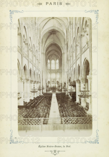Central nave of Notre-Dame in Paris, Paris - Église Notre-Dame, la Nef, photograph, Part of Photo album with sights in Paris, Versailles and the Bois de Boulogne., number: '25', Paris, c. 1900, photographer, pasteboard, paper, albumen print, albumendruk, height 155 mm x width 97 mm, parts of church interior: nave, Notre-Dame (Paris), A sepia-toned interior photograph of a large Gothic cathedral nave viewed from the rear toward the altar, showing tall pointed ribbed vaults and a long central aisle flanked by many rows of wooden chairs, high arcaded side aisles with clustered columns and ornate capitals, elevated balconies along the upper aisles, large arched windows at the far end admitting light, multiple decorative chandeliers suspended along the nave, carved stone screens and railings at the foreground, and symmetrical architectural details lining both sides of the central space.