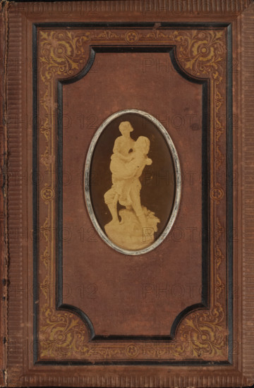 Poetry album of Everdine Goedbloed, scrapbook, verse album, Poetry album of Everdine Goedbloed with a photo of a sculpture on the front cover., compiler (person in literature): anonymous, Netherlands, 1860 - in or before 1879, compiler (person in literature), photographer, textile materials, biological material, inorganic material, paper, linen (material), metal, plant material, albumen print, autotype, embroidering, color on edge, photo album with a brown linen cover with blind embossing in gold and black and on the front cover an oval albumen print with a metal frame, the album contains paper sheets with gold on the edge, height 227 mm x width 151 mm x thickness 13 mm x width 294 mm, height 82 mm x width 51 mm, sculpture, A rectangular cover with a textured brown surface and a raised decorative border featuring ornate floral scrollwork in muted gold, with darker inset panels and ribbed edges, centered by an oval framed window containing a monochrome silhouette of a standing figure ca...