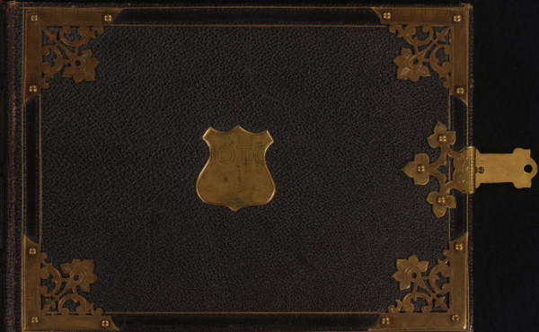 Photo album (empty), photograph album, slip-in album, Photo album with 36 pages with two gold-lined framed passe-partouts for cartes-de-visite side by side on every page., collector's mark: 'DIENST, VERSPREIDE, RIJKSKOLLEKTIES, A 910', 1860 - 1900, leather, pasteboard, biological material, inorganic material, paper, morocco (leather), metal, color on edges, cardboard slip-in album, covered with brown saffiano leather with four metal corners and a shield on the front cover, metal fittings and clasp, endpapers of iridescent paper, cardboard pages with gold edges, height 148 mm x width 212 mm x thickness 42 mm x width 418 mm, A dark textured surface bordered by ornate metallic corner pieces and edging, with floral and scrollwork metal decorations at the corners and along the right edge, a shield-shaped metal plate centered on the surface, and a latch mechanism with decorative metal elements visible on the right side.