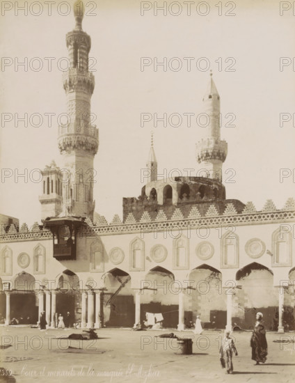 Courtyard and minarets of the Al-Azhar Mosque in Cairo, Cour et minarets de la mosquée El-Azhar, photograph, Part of Travel Album with 80 Photos of Egypt., negative number: '1369', photographer: Maison Bonfils, Cairo (city), c. 1870 - c. 1898, Ottoman Empire, North Africa, pasteboard, paper, albumen print, height 280 mm x width 218 mm, temple, shrine, Islam, Mohammedanism, An exterior view of a large ornate building with arched openings along its facade and decorative circular and pointed panel designs above each arch, a patterned crenellated parapet along the roofline, and tall slender towers rising behind it with carved and geometric detailing on their shafts and ornate balconies, one tower topped with a bulbous finial and another with a conical top and small spherical ornaments above it; a wooden projecting balcony with carved supports is attached to the facade, a rounded domed section with arched openings sits behind the parapet, and stone columns support the arcade below where a f...