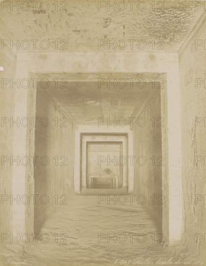 Thebes tomb de roi N. 9, Tomb of Ramses V and VI (KV9) in the Valley of the Kings, Thebes (Luxor), Burial chamber of an Egyptian pharaoh in Thebes (former title), photograph, Part of Travel album with 80 photos of Egypt., negative number: '941', photographer: Zangaki, C. & G., c. 1870 - c. 1890, North Africa, Upper Egypt, pasteboard, paper, albumen print, height 278 mm x width 219 mm, grave, tomb, Luxor, A narrow stone passage framed by a series of rectangular doorways receding into the distance, with textured walls and a rough floor, a ceiling showing uneven patches and marks, shallow reliefs and carvings visible on the side walls near the openings, and a muted monochrome tone across the entire scene.