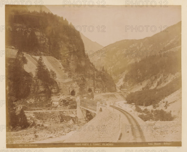 View of the Gotthard Pass with the Polmengo Tunnel, album page, photograph, This photo is part of an album., annotation: '1898', inscription: '207. San Gottardo, Faido ponte e tunnel Polmengo, Ediz. Bosetti - Bellagio', photographer: Bosetti (possibly), Gotthard Pass, Bellagio (Italy), 1898, Lombardy, paper, albumen print, height 265 mm, width 350 mm, railway, train, road, path, A sepia-toned mountain landscape showing steep rocky slopes with scattered trees and scrub, a curved railroad track running along a gravel embankment toward a metal truss bridge spanning a river gorge, two dark arched tunnel portals set into the rock face beyond the bridge, a few small rectangular buildings near the tunnel entrances and beside the river, and distant layered mountain ridges fading into the sky.