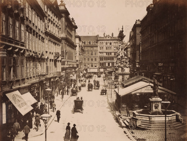 Wien. Der Graben., View of Der Graben in Vienna with shops, carts, pump and the Vienna Plague Column, photograph, Part of Travel Album with photos of sights in Germany and Austria and of works of art., photographer: A. Wimmer, Vienna, c. 1880 - c. 1895, Lower Austria, paper, albumen print, height 205 mm x width 266 mm, shop, store, monument, statue, utilitarian, public pump or water fountain, street (city(-scape) with figures, staffage), animal traction, animal-drawn vehicle (carriage etc.), piece of sculpture, reproduction of a piece of sculpture (sculpture), A wide sepia street scene with tall multi-story buildings flanking a broad roadway, a decorative column topped with sculptural figures rising near the right side, a stone fountain with a statue and basin in the foreground right, horse-drawn carriages and people walking along the street and sidewalks, awnings and streetlamps along building fronts, a row of windows and ornate architectural details on the left buildings, a canopy-co...