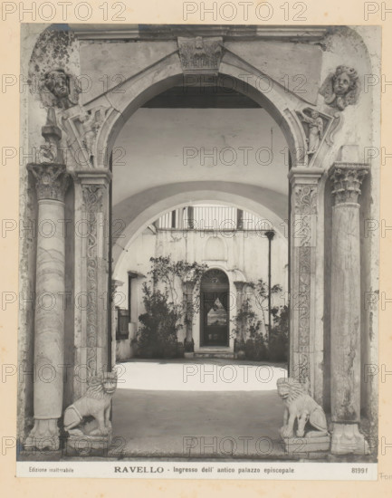 Entrance portal of the episcopal palace of Ravello, Ravello - Ingresso dell' antico palazzo episcopale, photograph, Part of Photo album with photographs of landmarks and works of art in Italy., number: '8199f', Ravello, c. 1875 - in or before 1907, photographer, paper, gelatin silver print, developed gelatin silver print, height 248 mm x width 195 mm, gate, entrance, interior, representation of a building, A stone archway with ornate carved columns frames a courtyard view, showing a series of arches receding into the background and a doorway set into a weathered wall; sculpted angelic faces and decorative reliefs adorn the upper corners and capitals of the columns, while two carved lion statues sit on low plinths at the base of the entrance; potted plants and small trees grow against the walls inside the courtyard, and a narrow railing runs along an upper level above the inner arch.