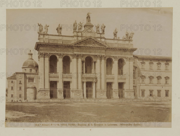 West facade of St. John Lateran in Rome, Italy, Basilica di S. Giovanni in Laterano (Alessandro Galilei), Roma, photograph, number: 'Po. Io. No. 5846.', photographer: Fratelli Alinari, Rome, 1852 - 1900, pasteboard, paper, albumen print, height 101 mm x width 141 mm, height 168 mm x width 224 mm, parts of church exterior and annexes: west facade, Sint-Jan Lateranen, A sepia photograph of a large classical building façade featuring tall columns and arched openings, with a triangular pediment above the central section and sculpted statues lined along the roofline; to the left a domed structure and adjacent rectangular building with small windows; to the right a multi-story building with regularly spaced windows and decorative window frames; the foreground shows an open paved and slightly grassy area leading up to the building steps, and the sky above is clear and pale.