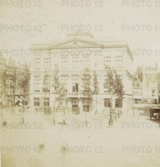 The Boymans Museum., Le Musée Boymans., Das Museum Boymans., Boyman's Museum, View of the Schielandshuis in Rotterdam, Rotterdam, stereograph, 1867 - 1870, photographer, pasteboard, paper, albumen print, albumendruk, height 88 mm x width 175 mm, Person, villa, Schielandshuis, A faded photograph of a large classical building with a triangular pediment and decorative facade, tall rectangular windows arranged across multiple stories, and a central entrance with arched doorways; trees stand in front of the building partially obscuring the lower windows, flanking a statue on a pedestal near the entrance; surrounding the main structure are adjacent narrower buildings with multiple windows and varied rooflines; in the foreground a paved open area shows lamp posts and low bollards, and a horse-drawn carriage is visible to one side, with faint figures and street details scattered across the scene.