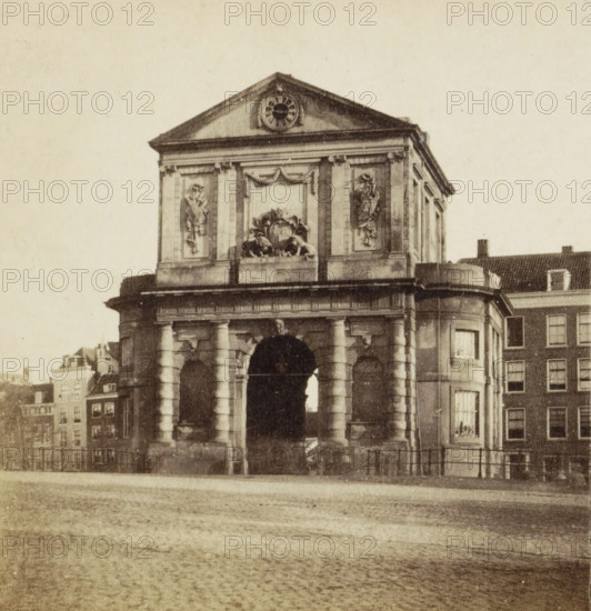 Rotterdam, Delftse Poort, View of the Delftse Poort in Rotterdam, stereograph, 1873 - 1890, photographer, pasteboard, paper, albumen print, height 85 mm x width 170 mm, city-gate, A stone archway structure with columns and a central arched passage sits in the foreground, topped by a rectangular upper section featuring sculpted relief panels and ornamental carvings, a triangular pediment with a circular decorative element at its center, and a carved crest flanked by decorative figures; adjoining buildings with rows of windows and pitched roofs are visible at the sides, and a paved surface extends in front of the structure.