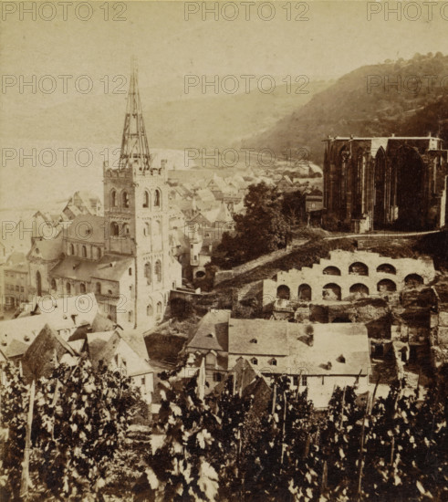 Bacharach. Panorama mit der Werner-Kapelle, Bacharach and the ruins of the Werner Chapel, Germany, Die Rheinlande, stereograph, number: '132.', photographer: Sophus Williams, Bacharach, 1877, Rhineland-Palatinate, pasteboard, paper, albumen print, albumendruk, height 86 mm x width 176 mm, city-view in general, 'veduta', dale, valley, ruin of church, monastery, etc. - QQ - small church, chapel, Wernerkapel, A sepia-toned aerial view of an old town with clustered rooftops and narrow streets, dominated by a tall church tower with an exposed spire structure and arched openings, adjacent to large Gothic ruins with high pointed window openings, terraced stone arches on a sloping hillside, scattered trees and foliage in the foreground, and distant hills fading into the pale sky.
