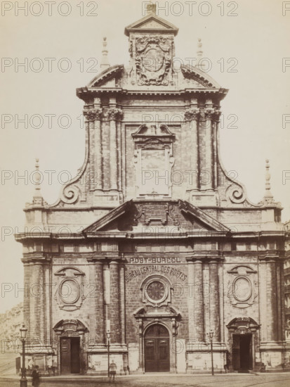 Façade of the Augustinian Church in Brussels, Belgium, photograph, Brussels, 1851 - 1900, photographer, paper, albumen print, height 284 mm x width 211 mm, parts of church exterior and annexes: façade, Augustijnenkerk (Brussel), A sepia-toned photograph of a large classical façade showing ornate stonework and architectural detailing, with a central entrance framed by columns and a rounded pediment above a circular clock, flanked by tall pilasters and decorative oval panels on either side, and an upper section featuring a triangular pediment, carved cartouche, scrolling volutes, and finial ornaments; lamp posts stand on the street in front and a few blurred human figures are visible near the doors.