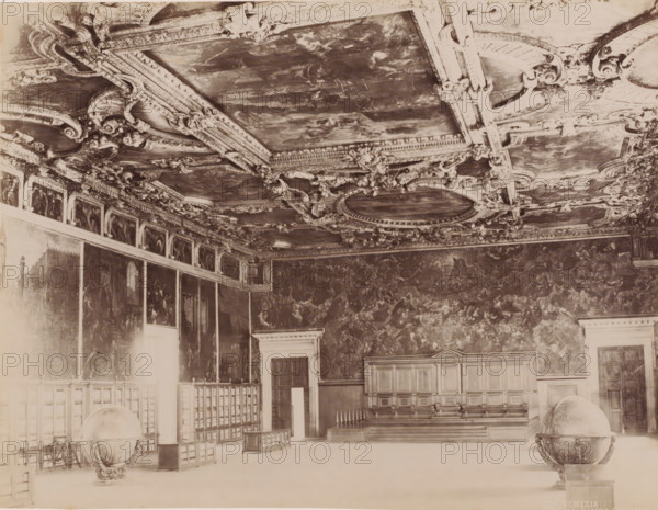 Hall of the Great Council in the Doge's Palace in Venice, Italy, Salle del maggior consiglio, Venezia, photograph, number: '154 ?', Venice, 1851 - 1900, photographer, pasteboard, paper, albumen print, albumendruk, height 323 mm x width 373 mm, globe, palace, (decorated) ceiling, Doge's Palace, A large ornate interior with a richly decorated ceiling featuring carved moldings and painted panels, walls covered with large-scale paintings, a raised wooden platform with paneled seating and a decorative railing, tall doors set into paneled wall sections, freestanding globes on carved stands placed on the floor, and rows of wooden partitions and small display cabinets along one side.