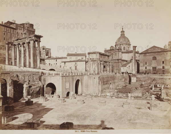 View of the Roman Forum in Rome, Italy, Fôro Romano, Roma, photograph, number: '53-', number: '3411.', number: '9', photographer: attributed to Giacomo Brogi, Rome, 1864 - 1881, Attributed to, pasteboard, paper, albumen print, height 276 mm x width 374 mm, landscape with ruins, excavation, archaeology, Roman Forum, A wide sepia-toned scene of ancient ruins and classical buildings with a foreground of a flat stone plaza scattered with square stone bases and low walls, a middle ground dominated by a large stone bridge with multiple arched openings and a balustrade, and to the left a partially preserved colonnade of tall columns supporting a broken entablature beside multi-story masonry buildings; to the right a cluster of ornate stone structures including a domed church with decorative architectural details and a façade with pilasters, and adjacent rectangular and temple-like buildings with single standing columns and arched doorways, all set beneath a pale sky.