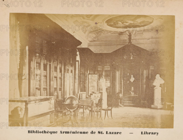 Monastery Library of San Lazzaro degli Armeni, Venice, Bibliothèque Arménienne de St. Lazare, Library, photograph, page, number: '6', c. 1874 - in or before 1879, photographer, paper, albumen print, height 89 mm x width 130 mm, Photo on unnumbered page opposite page 6., abbey, monastery, convent, Roman Catholic church, public library, San Lazzaro degli Armeni, A sepia-toned interior photograph showing a room with tall bookcases along the left wall and ornate ceiling decoration, a large canopy or dark drapery hanging toward the back, tables and chairs scattered across the floor, a globe mounted on a stand near a table, display cases and pedestals with busts and objects, and patterned flooring with soft light entering from the left.