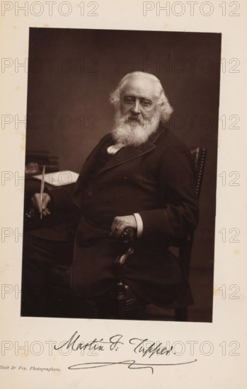 Portrait of Martin Farquhar Tupper, page, photomechanical print, inscription: 'Martin F. Tupper', photographer: Elliott & Fry, cliché maker: anonymous, c. 1881 - in or before 1886, paper, Woodburytype, height 145 mm x width 96 mm, Print opposite title page., Person, Martin Farquhar Tupper, portrait of a writer, An older man with a full white beard and wavy white hair sits in a dark suit on a carved wooden chair, one hand resting on the armrest and the other holding a slender object above a table with a book or papers, all set against a plain dark background.