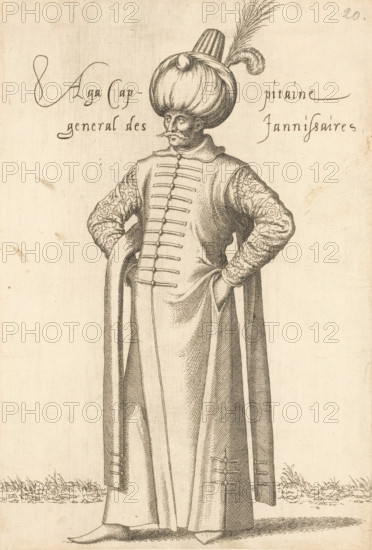Aga, cappitaine général des jannissaires, 'Aga' (commander in chief) of the janissaries, print, album page, book illustration, Print is part of an album., printmaker: Léon Davent, after drawing by Luca Penni (attributed to), after drawing by Nicolas de Nicolay (possibly), publisher: Guillaume Rouille (I), Lyon, 1555 - 1568, Léon Davet, Attributed to, paper, etching, mounted on album page, height 260 mm x width 176 mm, A tall figure stands facing forward wearing a long flowing robe with a buttoned front and wide sleeves, hands tucked into the robe at the hips, patterned sleeves with floral-like designs, a large rounded turban topped with a tall cylindrical element and a long feather, a narrow mustached face with a prominent nose, shoes partly visible beneath the robe, simple ground with small tufts of grass around the feet, and faint handwritten markings near the upper edges of the page.