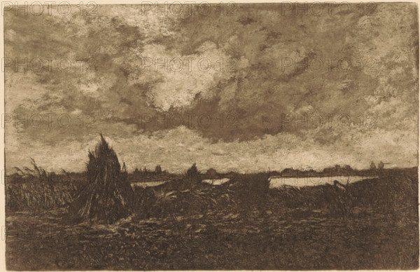 Landscape with river near Gouda, print, In the foreground a figure in a field., printmaker: Jan Willem Nortier (signed by artist), 1874 - 1919, paper, etching, intaglio printmaking technique, height 125 mm x width 195 mm, river, Gouda, A wide, muted landscape rendered in dark, earthy tones shows a low horizon with marshy ground and rough vegetation in the foreground, including a prominent tall, bundled clump of reeds or grasses slightly left of center; a narrow reflective water channel runs near the horizon, flanked by low, indistinct silhouettes of distant vegetation and small mounds; above the horizon a vast, textured sky fills most of the image with broad, mottled cloud formations in varying shades, creating a heavy, overcast appearance across the scene.