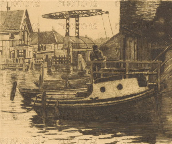 View of the drawbridge between the Kalkmarkt and the 's Gravenhekje in Amsterdam, print, Seen from the Oude Schans., signature: 'Witsen', watermark, inscription: 'proefdruk', printmaker: Willem Witsen (signed by artist), Amsterdam, c. 1911, Willem Witsen, printmaker, paper, etching, intaglio printmaking technique, etching with plate tone, proof, height 150 mm x width 180 mm, city-view in general, 'veduta', canals, waters (in city), bridge, Kalkmarkt, A sepia-toned etching shows a waterfront scene with a large moored boat in the foreground, visible hull details, rounded windows, and fenders hanging along its side, with rippled water reflections beneath. Wooden docks and railings surround the boat, and a figure leans on a railing near the center, head bowed and arms resting forward. Buildings with pitched roofs, tiled and weathered siding, and small windows line the left and right banks, connected by wooden fences and platforms. In the background an industrial metal structure with two ve...