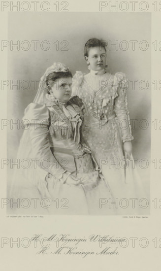 Portrait of Emma, Queen Regent of the Netherlands, and Wilhelmina, Queen of the Netherlands, photomechanical print, Portrait of Emma and Wilhelmina. Their names and titles in the lower margin., photographer: Henri de Louw, cliché maker: Emrik & Binger, Haarlem, 1897, paper, collotype, photogravure, height 264 mm x width 195 mm, The title mentioned here refers to the highest title obtained by the sitter, not necessarily to the title the sitter bears in this image., Person, Emma (Queen consort of the Netherlands), Wilhelmina of the Netherlands, A sepia-toned studio portrait showing two women in ornate dresses; one woman is seated wearing a high-necked gown with layered ruffles, a veil, and a headpiece of flowers, her hands resting in her lap, while the other woman stands slightly behind and to the side wearing a high-collared gown with puffed sleeves, lace and embroidered detailing, and she holds a folded fan at her side; both have hair styled up and neutral facial expressions, and the b...