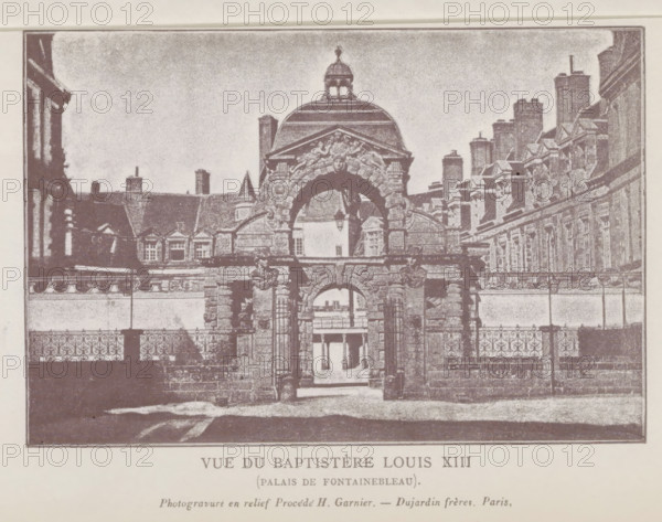 View of the entrance gate of the castle of Fontainebleau, Vue du Baptistère Louis XIII (Palais de Fontainebleau), page, photomechanical print, Fontainebleau, cliché maker: Dujardin Frères, Paris, c. 1859 - in or before 1869, photographer, paper, photoaquatint, photogravure and relief process H. Garnier, height 98 mm x width 147 mm, façade (of house or building), gate, entrance, Palais de Fontainebleau, A monochrome image showing an ornate stone gateway with a large rounded arch topped by sculpted reliefs and a domed pavilion above, flanked by stone columns and decorative balustrades, with an iron fence in front and architectural facades with rows of windows and chimneys extending on both sides behind the gateway, and a courtyard visible through the arch.