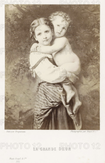 La grande sœur, Photo reproduction of the painting La grande sœur, reproduction, page, photomechanical print, name: 'Goupil', photographer: Goupil & Cie., France, cliché maker: anonymous, after painting by William-Adolphe Bouguereau, Paris, in or after 1865 - in or before 1869, paper, Woodburytype, Woodburytypepie, height 121 mm x width 90 mm, girl (child between toddler and youth), child, A sepia-toned image of a young girl holding a naked toddler against her chest, the girl facing forward with a calm expression and the toddler resting an arm around her shoulders while looking outward, both with soft facial features and curly hair on the toddler; the girl wears a blouse with puffed sleeves and a striped skirt with draped fabric, and the toddler's legs hang down with visible feet; the background shows indistinct foliage and textured shading.