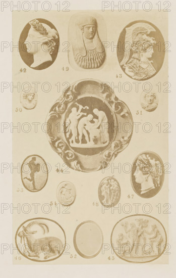 Thirteen cameos, photograph, page, number: '42 - 54', photographer: F. Cole, c. 1857 - in or before 1867, paper, albumen print, height 162 mm x width 99 mm, historical persons (portraits and scenes from the life) (profile portrait), gem, gemstone, carving, applied arts, A vertical sheet showing a grid of oval and circular carved reliefs and cameos on a pale background, featuring multiple profile portraits of classical-style figures, a central ornate oval plaque with a group scene of standing and bent figures, several small roundels with heads and torsos, a reclining horned animal in one lower oval, and decorative carved borders around some of the pieces.