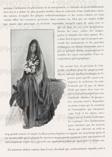 Veiled woman with flowers, page, photomechanical print, photographer: Constant Puyo, France, cliché maker: anonymous, c. 1886 - in or before 1896, paper, autotypie, height 153 mm x width 85 mm, adult woman, cut flowers, nosegay, bunch of flowers, veil, A grayscale photograph of a seated woman wearing a long flowing dress and a sheer veil, holding a bouquet of flowers in her lap, framed by a rectangular border and positioned on the left side of a page filled with printed text running around the image.