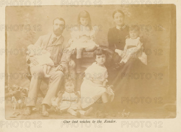 Group portrait of the family of Samuel Simmins, photograph, page, inscription: 'Our best wishes to the Reader.', c. 1882 - in or before 1887, photographer, paper, albumen print, albumendruk, height 95 mm x width 148 mm, Photo on frontispiece., Person, Samuel Simmins, family group, especially parents with their child(ren), anonymous historical persons depicted in a group, in a group-portrait, A faded sepia photograph showing a seated man with a beard wearing a suit and tie holding a small child in a light dress, a woman in a dark dress with a high collar seated nearby holding another small child in a light dress, and several children arranged around them wearing light-colored dresses and shoes; the background includes a painted backdrop with indistinct foliage and the image has a worn border.
