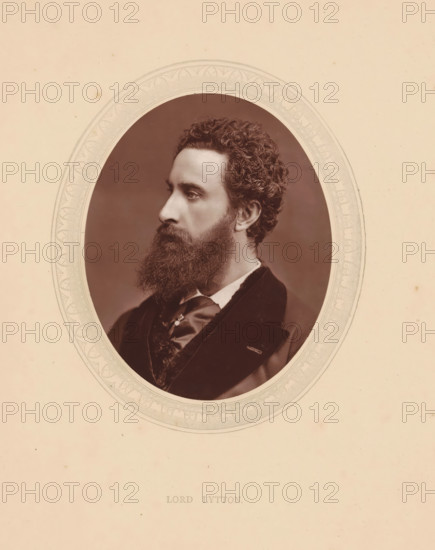 Lord Lytton, page, photomechanical print, photographer: Lock & Whitfield, cliché maker: anonymous, c. 1871 - in or before 1876, paper, Woodburytype, Woodburytypie, height 115 mm x width 89 mm, Person, Robert Bulwer-Lytton, writer, poet, author, historical persons (portraits and scenes from the life) ((full) bust portrait), A sepia portrait of a man shown in profile within an ornate oval frame on a pale background, the man has curly hair and a full beard, a high forehead and defined nose, he is wearing a dark jacket with a vest and a tied cravat, the oval frame features decorative patterns and the surrounding paper shows light spots and small blemishes.