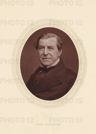 Lord Chelmsford, page, photomechanical print, photographer: Lock & Whitfield, cliché maker: anonymous, c. 1871 - in or before 1876, paper, Woodburytype, height 115 mm x width 89 mm, Person, Frederic Thesiger, politician, eg party leader, historical persons (portraits and scenes from the life) ((full) bust portrait), An oval portrait shows an older man from the chest up wearing a dark coat with wide lapels and a high-collared shirt, his hair swept to the side with gentle waves and a slightly receding hairline, and his face marked by fine lines and a neutral expression; the portrait is set against a plain dark background and surrounded by a decorative oval border with repeating leaf-like motifs, all on a light-colored paper.