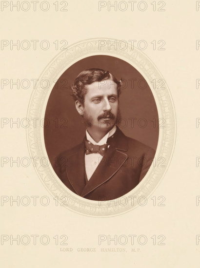 Lord George Hamilton, MP, page, photomechanical print, photographer: Lock & Whitfield, cliché maker: anonymous, c. 1871 - in or before 1876, paper, Woodburytype, height 115 mm x width 89 mm, Person, politician, eg party leader, historical persons (portraits and scenes from the life) ((full) bust portrait), An oval sepia portrait of a man is centered on a pale background with a decorative oval border around the photograph; the man has wavy hair, sideburns, a mustache, and a somber expression, and he is shown from the chest up wearing a dark suit jacket with light piping, a high-collared shirt, and a patterned bow tie.