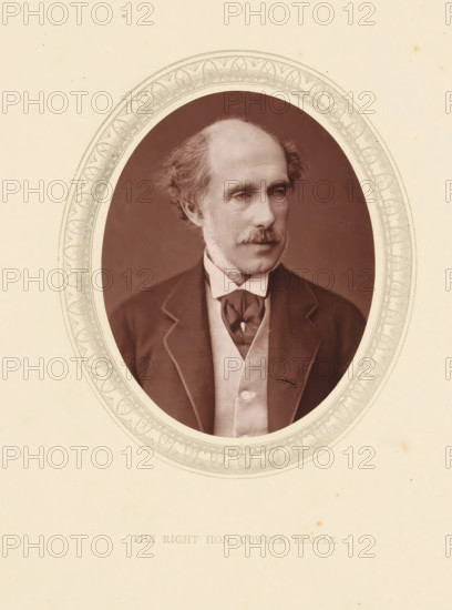 The right hon. Cowper-Temple, page, photomechanical print, photographer: Lock & Whitfield, cliché maker: anonymous, c. 1871 - in or before 1876, paper, Woodburytype, Woodbury Process, height 115 mm x width 89 mm, Person, William Cowper-Temple, politician, eg party leader, historical persons (portraits and scenes from the life) ((full) bust portrait), An oval sepia portrait of a middle-aged man with thinning hair and sideburns, shown from the chest up wearing a dark jacket with light piping, a light vest, a high-collared shirt, and a tied cravat, set against a plain darker background and surrounded by a decorative oval frame on a light cream paper.