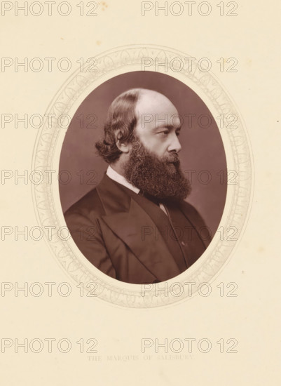 The marquis of Salisbury, page, photomechanical print, photographer: Lock & Whitfield, cliché maker: anonymous, c. 1871 - in or before 1876, paper, Woodburytype, Woodbury Process, height 115 mm x width 89 mm, Person, Robert Gascoyne-Cecil (Marquis of Salisbury), prime minister, historical persons (portraits and scenes from the life) ((full) bust portrait), An oval sepia photographic portrait of a man shown in profile facing right, with a high forehead, wavy hair at the back of his head, and a full bushy beard; he is wearing a dark suit jacket, a white shirt collar, and a dark necktie, and the portrait is set against a neutral background with a decorative oval border and a plain off-white surrounding area.
