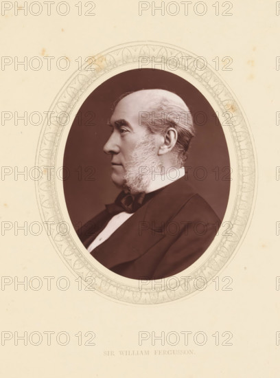 Sir William Fergusson, page, photomechanical print, photographer: Lock & Whitfield, cliché maker: anonymous, c. 1871 - in or before 1876, paper, Woodburytype, Woodbury Process, height 115 mm x width 89 mm, Person, William Fergusson, barber, surgeon, historical persons (portraits and scenes from the life) ((full) bust portrait), A sepia-toned oval portrait of an older man shown in profile facing left, framed by a decorative oval border with intricate floral and leaf patterns, set against a pale cream background with small scattered spots and stains; the man has a high forehead, swept-back hair, prominent sideburns that extend down his cheeks, a straight nose, and a closed-mouth expression, and he is wearing a dark suit jacket, a white shirt collar, and a bow tie.