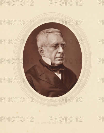 Sir George Biddell Airy, page, photomechanical print, photographer: Lock & Whitfield, cliché maker: anonymous, c. 1871 - in or before 1876, paper, Woodburytype, Woodbury Process, height 115 mm x width 89 mm, Person, George Biddell Airy, politician, eg party leader, historical persons (portraits and scenes from the life) ((full) bust portrait), An oval photographic portrait centered on a cream-colored background, showing an older man in profile facing right with light-colored hair and pronounced sideburns, small round eyeglasses, a high white collar and dark formal coat with a tied cravat, the oval frame featuring a decorative patterned border.