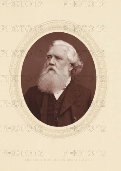 The right hon. Austen Henry Layard, page, photomechanical print, photographer: Lock & Whitfield, cliché maker: anonymous, c. 1871 - in or before 1876, paper, Woodburytype, Woodbury Process, height 115 mm x width 89 mm, Person, Austen Henry Layard, writer, poet, author, historical persons (portraits and scenes from the life) ((full) bust portrait), An oval portrait of an older man with thick white hair and a full white beard set against a dark background, the man wearing a dark suit jacket and waistcoat with a white shirt collar visible, framed by a decorative oval border on a light-colored mat.