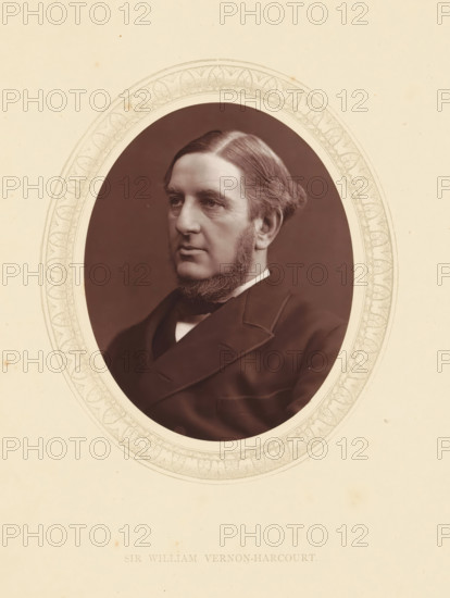 Sir William Vernon-Harcourt, page, photomechanical print, photographer: Lock & Whitfield, cliché maker: anonymous, c. 1871 - in or before 1876, paper, Woodburytype, Woodbury Process, height 115 mm x width 89 mm, Person, William Vernon Harcourt, lawyer, attorney at law, historical persons (portraits and scenes from the life) ((full) bust portrait), A sepia-toned oval portrait of a middle-aged man shown from the shoulders up, set against a dark background and surrounded by a decorative oval mat with a repeating leaf-like pattern, the man has a side-parted hairstyle with hair combed back and sideburns that connect to a trimmed beard along his jaw, his facial expression is neutral with a slightly downturned mouth and he is dressed in a dark formal coat and white collar visible at the neckline.
