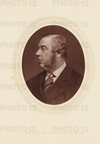 The right hon. George Sclater-Booth, page, photomechanical print, photographer: Lock & Whitfield, cliché maker: anonymous, c. 1873 - in or before 1878, paper, Woodburytype, Woodbury Process, height 115 mm x width 89 mm, Person, George Sclater-Booth, politician, eg party leader, historical persons (portraits and scenes from the life) ((full) bust portrait), A sepia-toned oval portrait of a middle-aged man shown in profile facing left, with neatly combed hair and prominent sideburns, wearing a dark suit jacket, a collared shirt, and a patterned necktie, set against a dark background within a decorative light-colored oval mat on a pale textured paper.