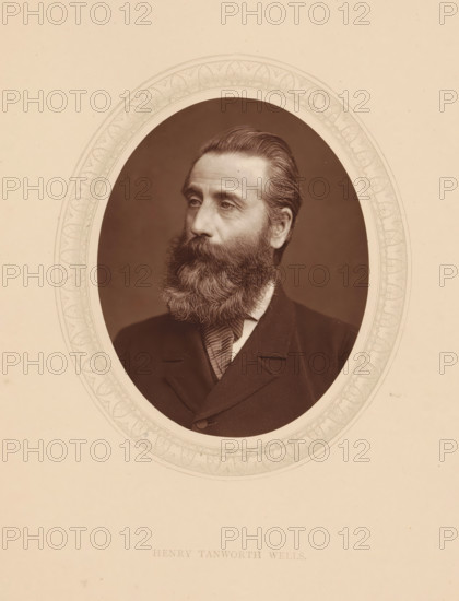 Henry Tanworth Wells, page, photomechanical print, photographer: Lock & Whitfield, cliché maker: anonymous, c. 1873 - in or before 1878, paper, Woodburytype, Woodbury Process, height 115 mm x width 89 mm, Person, portrait, self-portrait of painter, historical persons (portraits and scenes from the life) ((full) bust portrait), A sepia-toned oval portrait of a middle-aged man with a full beard and neatly combed hair, shown from the chest up and turned slightly to his left, wearing a dark suit jacket and a striped necktie, set against a plain dark background and surrounded by an ornate oval decorative border on a light beige mount.