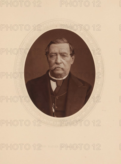 Lord Napier of Magdala, page, photomechanical print, photographer: Lock & Whitfield, cliché maker: anonymous, c. 1873 - in or before 1878, paper, Woodburytype, Woodbury Process, height 115 mm x width 89 mm, Person, Robert Napier, scholar, philosopher, historical persons (portraits and scenes from the life) ((full) bust portrait), An oval sepia portrait of an older man with a large, bushy mustache and neatly combed hair, wearing a dark suit jacket, waistcoat, and a high-collared shirt with a cravat, set against a plain darker background and surrounded by an ornate pale decorative border on a lighter sheet.