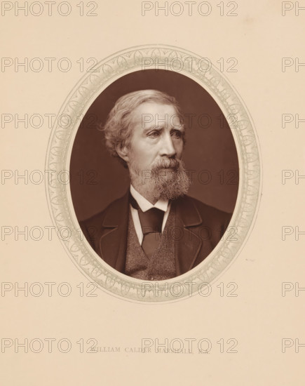 William Calder Marshall, RA, page, photomechanical print, photographer: Lock & Whitfield, cliché maker: anonymous, c. 1873 - in or before 1878, paper, Woodburytype, Woodbury Process, height 115 mm x width 89 mm, Person, portrait, self-portrait of sculptor, historical persons (portraits and scenes from the life) ((full) bust portrait), A sepia-toned oval portrait of a middle-aged man with wavy hair and a full beard, shown from the shoulders up, wearing a dark suit jacket, a vest, and a tie, framed by an ornate patterned oval border set against a plain light background.