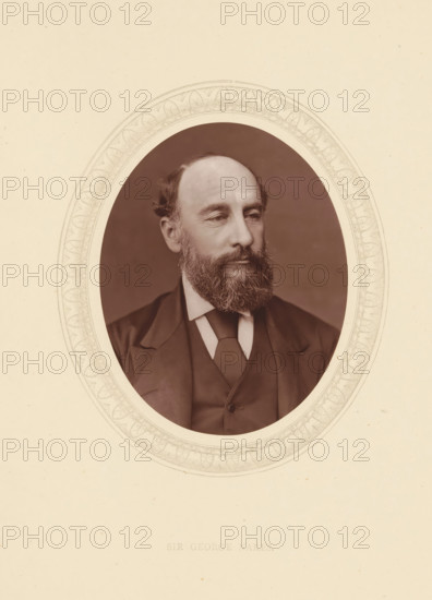 Sir George Nares, page, photomechanical print, photographer: Lock & Whitfield, cliché maker: anonymous, c. 1873 - in or before 1878, paper, Woodburytype, Woodbury Process, height 115 mm x width 89 mm, Person, George Nares, officer, historical persons (portraits and scenes from the life) ((full) bust portrait), An oval sepia photograph of a middle-aged man with a full beard and receding hairline set within an ornate etched oval border on a pale background, showing the man in a dark suit jacket, waistcoat, and tie, his head turned slightly to the side and his expression neutral, with visible facial features including a beard, mustache, ears, and short hair, and the etched border featuring repeating decorative motifs.