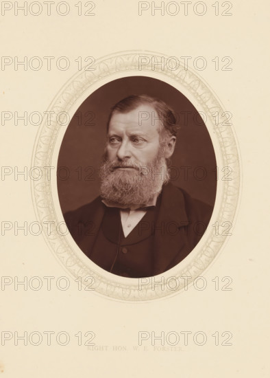 Right hon. WE Forster, page, photomechanical print, photographer: Lock & Whitfield, cliché maker: anonymous, c. 1873 - in or before 1878, paper, Woodburytype, Woodbury Process, height 115 mm x width 89 mm, Person, William Edward Forster, philanthropist, historical persons (portraits and scenes from the life) ((full) bust portrait), A sepia-toned oval portrait of a middle-aged man with a full beard and mustache, short combed hair, and a solemn expression, shown from the shoulders up wearing a dark suit jacket, waistcoat, and bow tie, set against a dark background and surrounded by a decorative oval border on a light paper background.