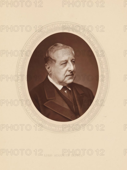 Lord Augustus Loftus, page, photomechanical print, photographer: Lock & Whitfield, cliché maker: anonymous, c. 1875 - in or before 1880, paper, Woodburytype, Woodbury Process, height 115 mm x width 89 mm, Person, Augustus Loftus, diplomacy, diplomat, historical persons (portraits and scenes from the life) ((full) bust portrait), A sepia-toned oval portrait of an older man shown from the chest up, facing slightly to the viewer's right, with short swept-back hair and sideburns, wearing a dark formal coat with wide lapels and a vest, set against a darker oval background framed by an ornate decorative border, all on a light beige mount.