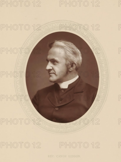 Rev. Canon Liddon, page, photomechanical print, photographer: Lock & Whitfield, cliché maker: anonymous, c. 1876 - in or before 1881, paper, Woodburytype, Woodbury Process, height 115 mm x width 89 mm, Person, Henry Liddon, theologian, historical persons (portraits and scenes from the life) ((full) bust portrait), An oval sepia portrait of an older man shown in profile facing left, with light-colored hair neatly combed back and short sideburns, wearing a dark jacket with a high white collar, set against a darker oval background and surrounded by a decorative light-colored oval border on a pale page.