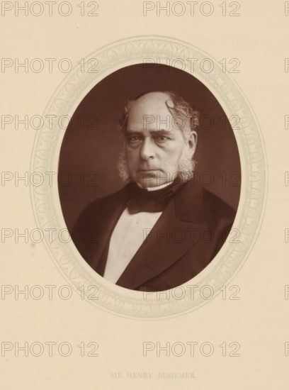 Sir Henry Bessemer, page, photomechanical print, photographer: Lock & Whitfield, cliché maker: anonymous, c. 1876 - in or before 1881, paper, Woodburytype, Woodbury Process, height 115 mm x width 89 mm, Person, Henry Bessemer, engineering, historical persons (portraits and scenes from the life) ((full) bust portrait), An oval sepia portrait of an older man with a high forehead and receding hairline, sideburns, and a serious expression, dressed in a dark coat, bow tie, and light waistcoat, set against a dark background and bordered by a decorative oval frame on a light beige background.