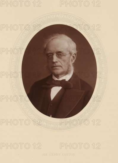 Sir Henry Cotton, page, photomechanical print, photographer: Lock & Whitfield, cliché maker: anonymous, c. 1876 - in or before 1881, paper, Woodburytype, Woodbury Process, height 115 mm x width 89 mm, Person, Henry Cotton, magistracy, judges, historical persons (portraits and scenes from the life) ((full) bust portrait), An oval portrait shows an older man with light hair and sideburns wearing round spectacles and a dark formal jacket with a bow tie and waistcoat; the portrait is set against a dark background and surrounded by a decorative light-colored oval mat with a patterned border, all on a larger light-colored sheet.